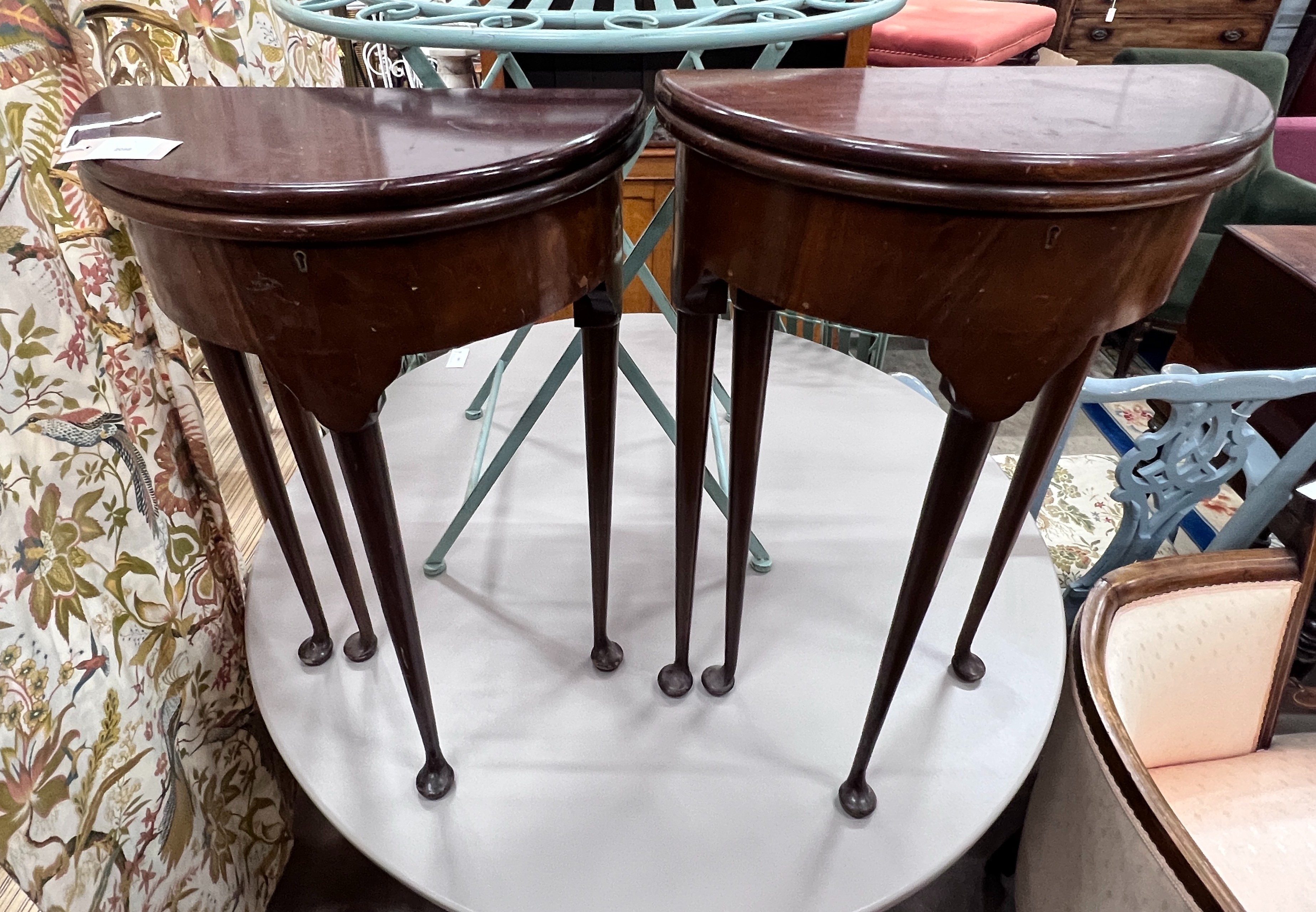 A pair of small George II style red walnut D shaped folding tea tables, width 45cm, depth 22cm, height 74cm